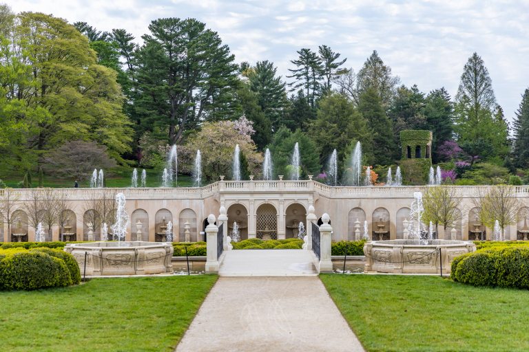 White stone structure with fountains jetting from the top