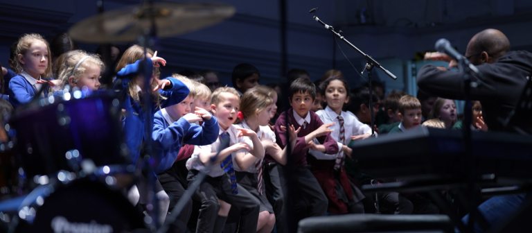 a group of students perform with bassistry on a stage