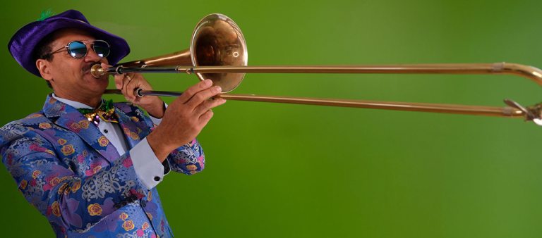 An adult playing the trombone.