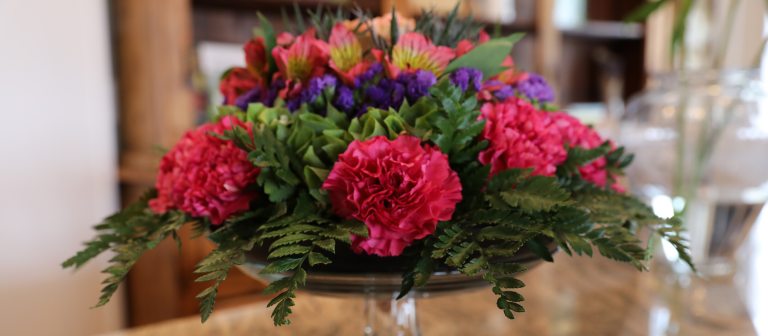 cut flower arrangement including ferns and carnations