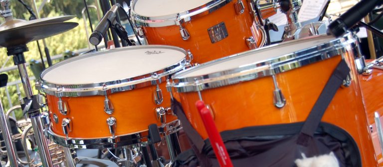 closeup of trio of orange drums in a drumset