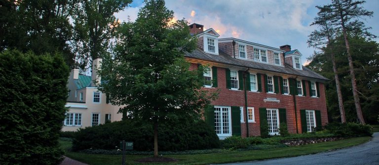 a brick house with ivy covering one side