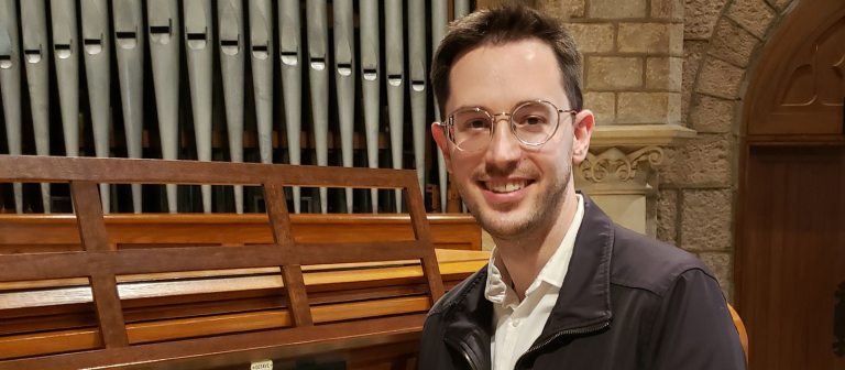 Adult sitting at an organ console