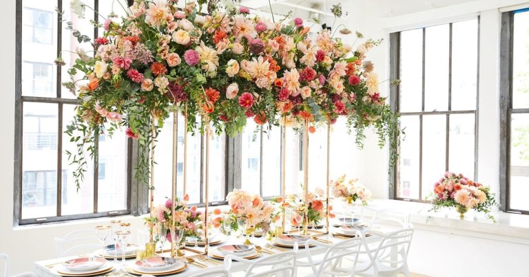 Floral arrangements hanging at the roof of an event space. 
