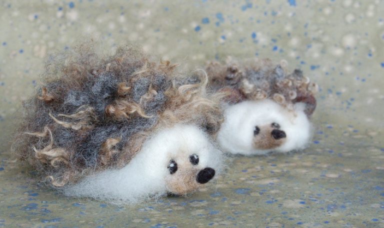 Two cutesy felt made hedgehogs.