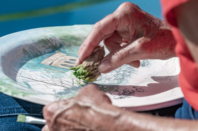 A persons hands creating a watercolor image at Longwood Gardens.