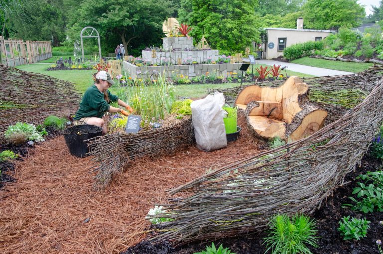 person working on garden beds 