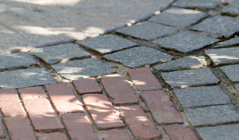 A red and gray close up of a brick path.