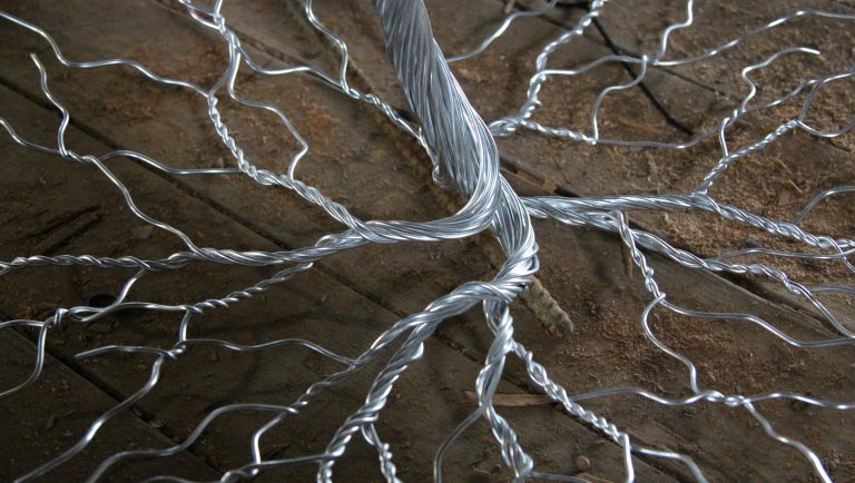 Tree trunk and roots constructed in twisted silver metal