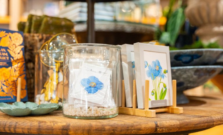 Products for sale in The Garden Shop featuring blue poppies.