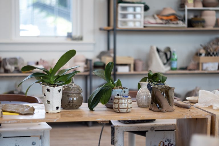 Clay pots on a table planted with orchids