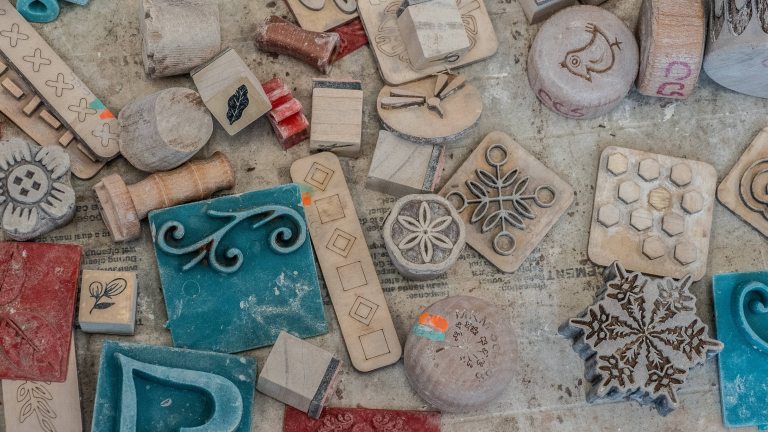 A variety of holiday stamps laying on a work table.