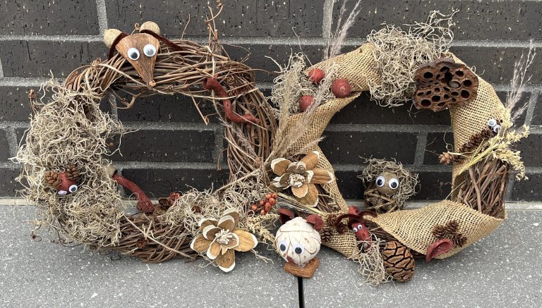 Two wreaths hand decorated with natural materials