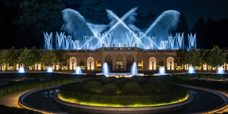 White-lit fountains against a night sky.