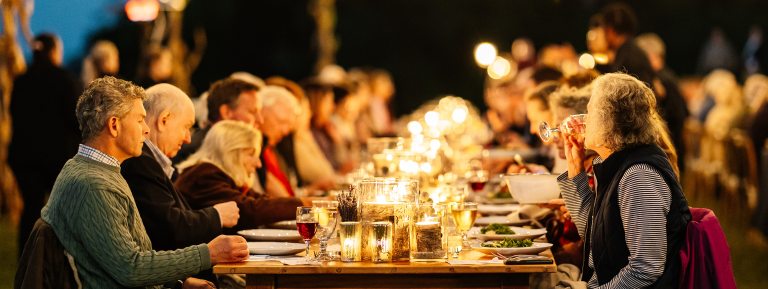 candlelit dinner outside in a field