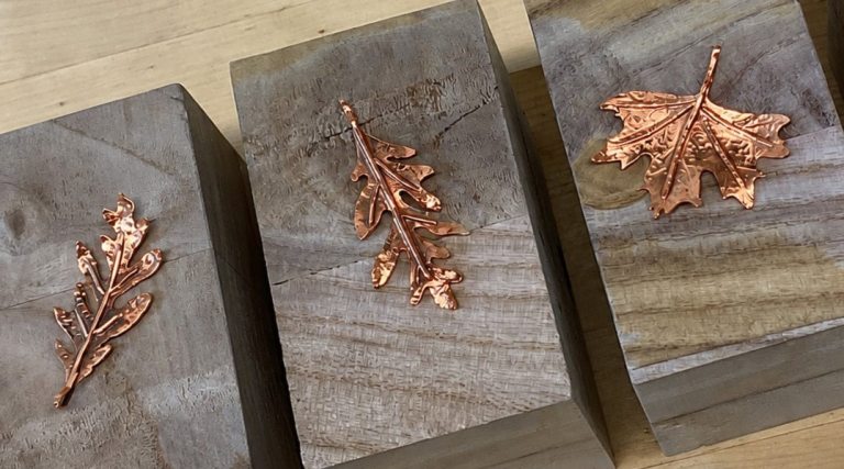 3 handcrafted leaves made out of hammered copper