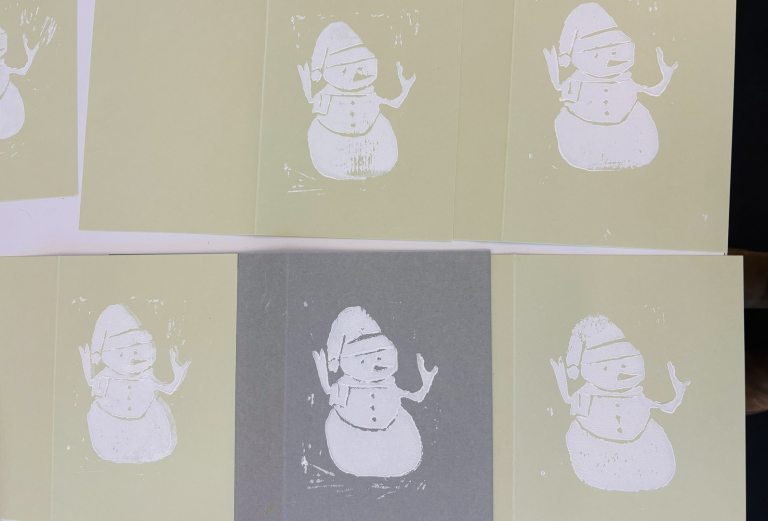 Handmade cards, featuring a printed snowman in white ink.