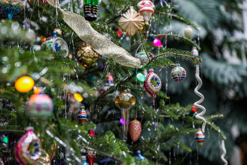 Colorful and historic ornaments adorn a pine tree as decoration