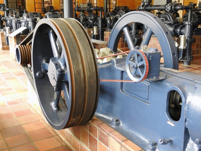close up view of a historic pump with two wheels