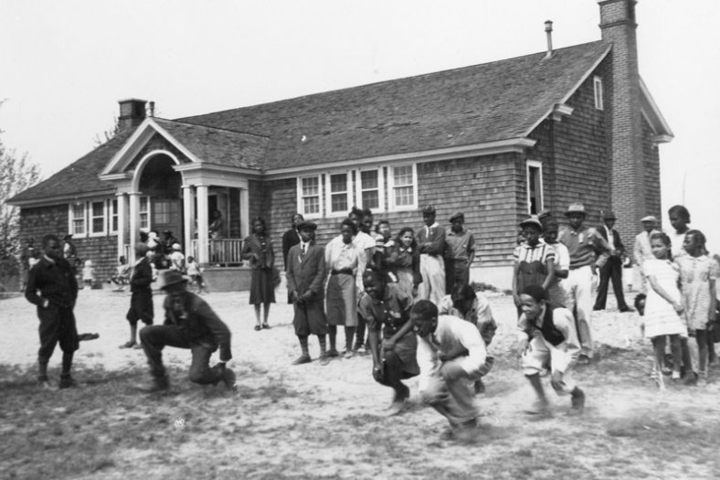 African American school built by Pierre du Pont in Delaware, with students playing in front of the one room building
