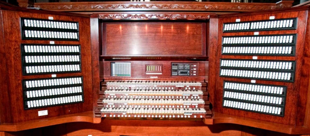 an organ console with keyboards and buttons