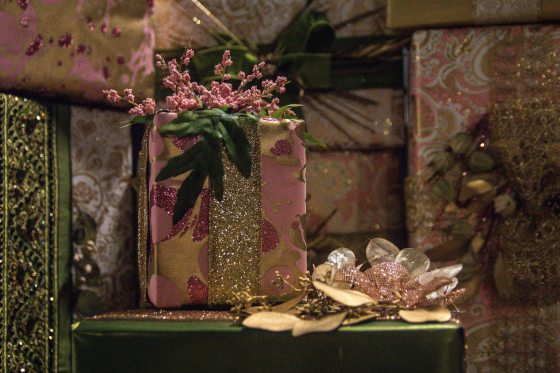 beautifully wrapped gifts using pink and green wrapping paper and ribbons and plant foliage