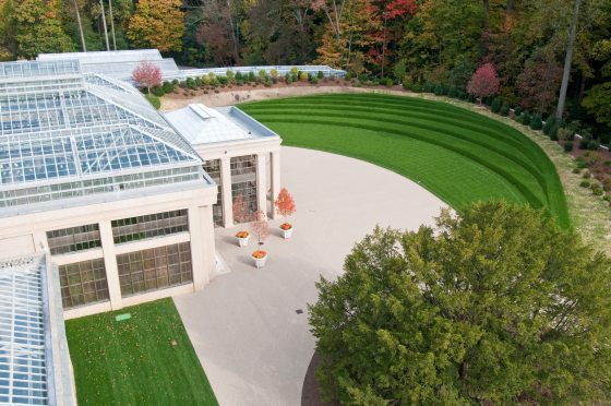 Aerial view of a glass Conservatory and sweeping grass terrace
