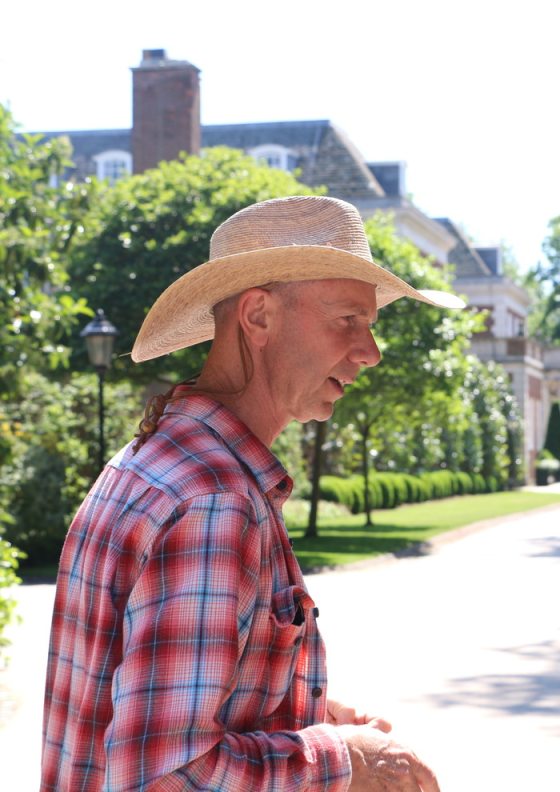 a person in a cowboy hat and flannel 