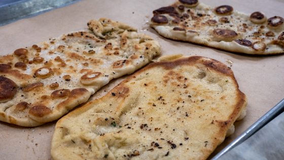 three naan loaves on a baking pan