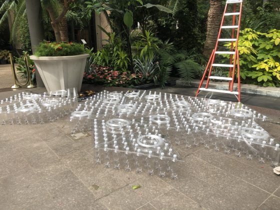 Acrylic panels with bottles laying on a stone floor