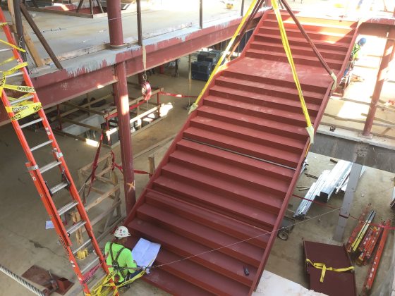 an unfinished red steel staircase in a new construction building