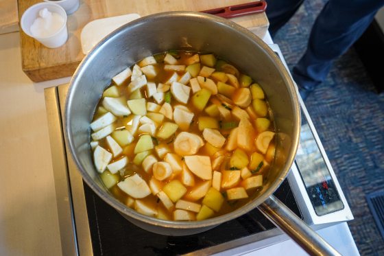 A pot on the stove with ingredients being made into a bisque