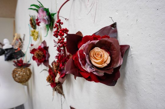 dried red flowers pinned to a wall