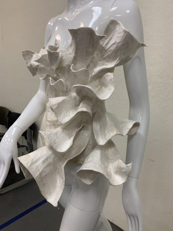 a white flowy bodice on a mannequin