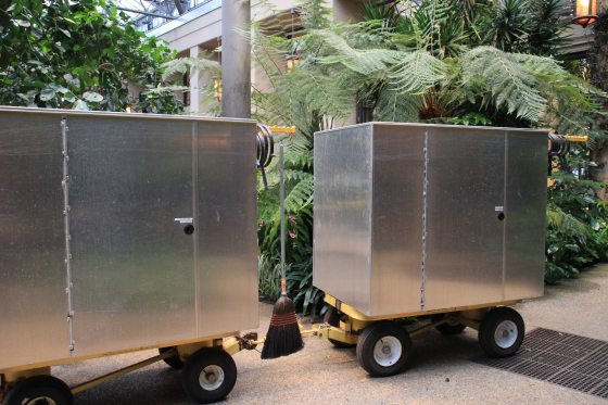 two closed metal wagons used for transporting orchids