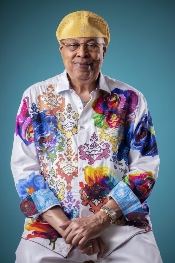 portrait of a smiling person wearing brightly colored clothes