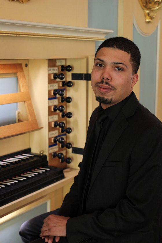 portrait of musician seated at organ console