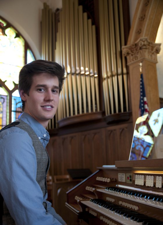 portrait of musician seated at organ console