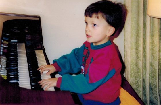 a child sitting at an organ console