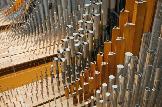 A up close image of silver organ pipes. 
