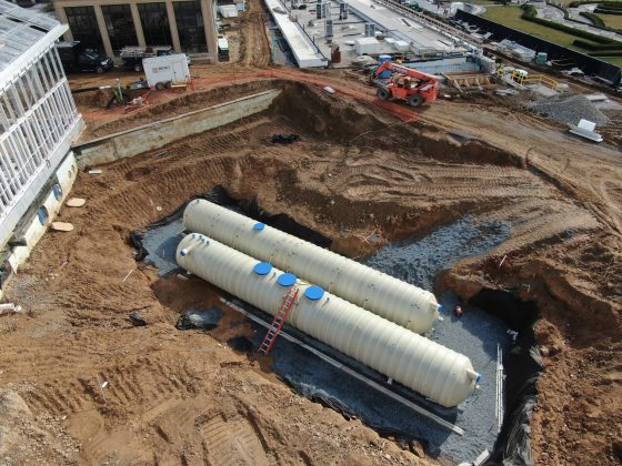 two large tanks being buried underground