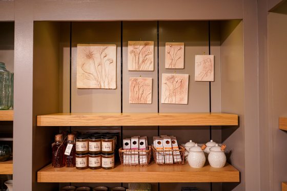 Shelves on display in The Garden Shop featuring botanical prints.