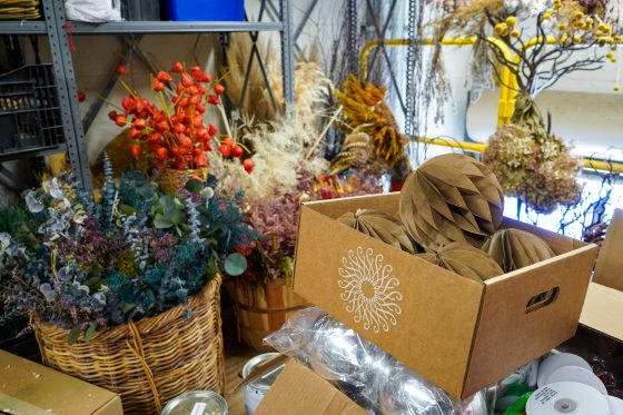 Boxes and baskets of dried floral materials.