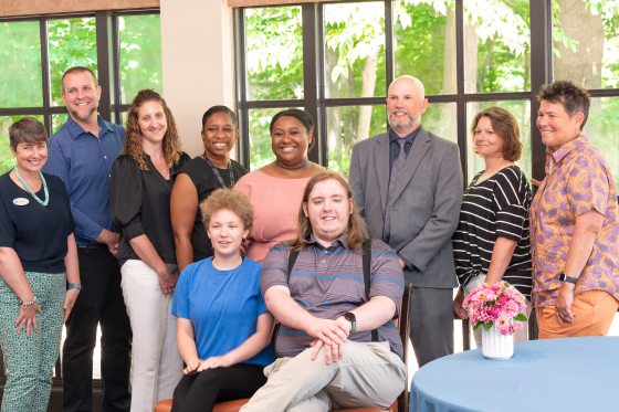 Eight representatives from Longwood Gardens, the Chester County Intermediate Unit (CCIU), and the PA Department of Labor & Industry’s Office of Vocational Rehabilitation (OVR) stand behind two students who are seated to celebrate the completion of the MY WORK summer employment program. 