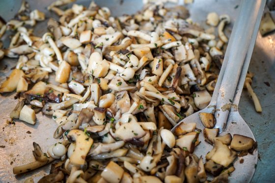 Chopped up mushroom being cooked on a stove.