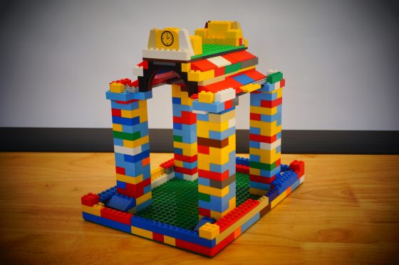 A birdhouse made out of multi-colored legos. 