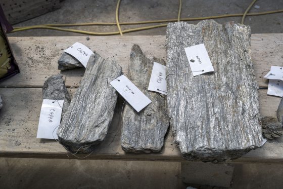 Large pieces of stone tagged and lying on wood planks.