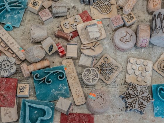 A variety of holiday stamps laying on a work table.
