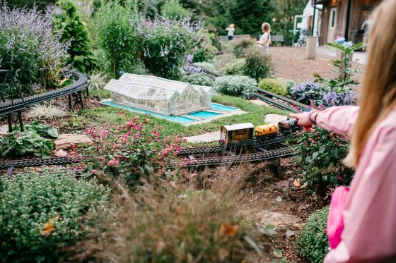 A child points to a model train on display at Longwood Gardens.