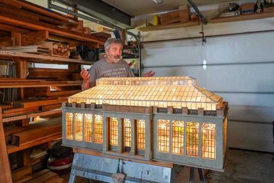 A model of the Main Conservatory at Longwood Gardens sitting in a workshop.
